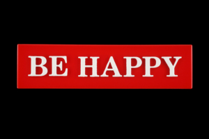 Red rectangle with white block text that says BE HAPPY